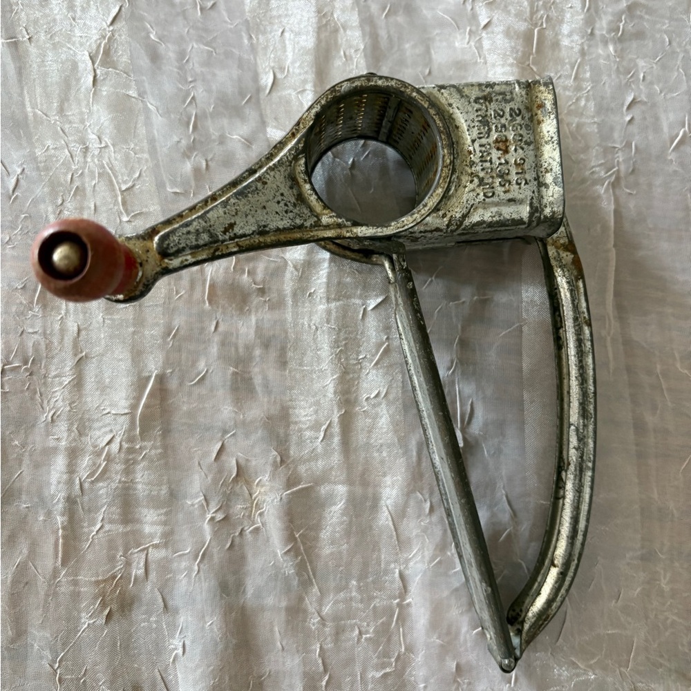 Vintage Metal Handheld Grinder with Red Handle